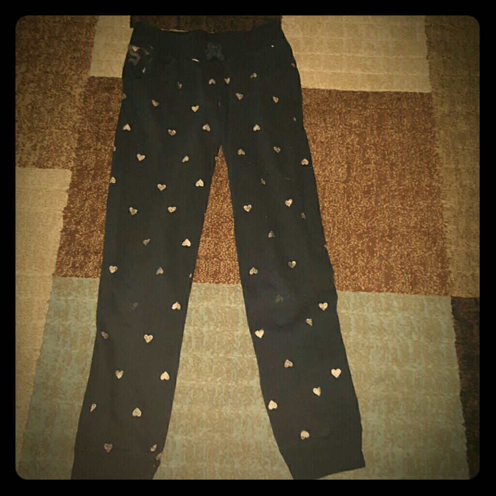 Black joggers with golden glitter hearts